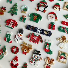 a white plate topped with lots of different types of beaded christmas decorations on top of it