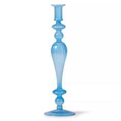 a tall blue glass candle holder on a white background with no one around it to see the light