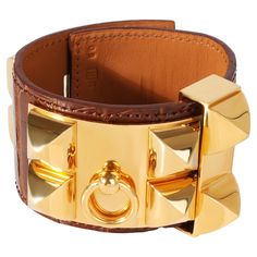 Hermes Collier De Chien Brown Leather Gold Tone Cuff PRIMARY DETAILS SKU: 120288 Listing Title: Hermes Collier De Chien Brown Leather Gold Tone Cuff Condition Description: Retails for 2125 USD. In excellent condition. Length is adjustable. Brand: Hermès Collection/Series: Collier De Chien Metal Type: Base Metal Pre-Owned Jewelry Condition: Excellent SIDE STONE INFORMATION Original Box?: No Original Papers?: No Formal Gold Leather Cuff Bracelet, Gold Leather Cuff Bracelet For Formal Occasions, Luxury Gold Leather Bracelets, Luxury Cuff Bracelets For Party, Luxury Yellow Gold Cuff Bangle, Formal Leather Cuff Jewelry, Elegant Brown Cuff Bracelet For Formal Occasions, Formal Brown Leather Cuff Bracelet, Luxury Leather Cuff Jewelry