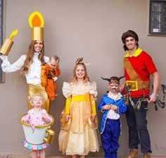 three adults and two children dressed up in costumes