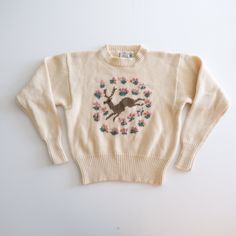 "Gorgeous chunky knit vintage sweater by classic brand JG Hook! Beautiful thick winter white/cream wool.  Brown knit deer with pink flower rosettes.  Crew neck style with sightly cropped shape.  Cute anchor label.  Brand: JG Hook Tag size: Large (runs smaller) Approximate measurements:  21\" from armpit to armpit 22\" long 24\" sleeve length (from underarm to cuf) Condition: EXCELLENT vintage"