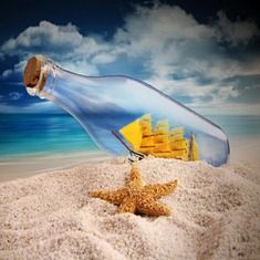 a message in a bottle on the beach with a starfish and yellow building behind it