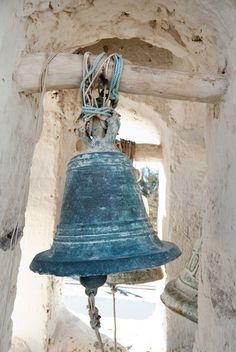 a bell hanging from the side of a building