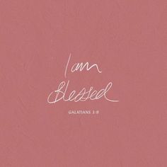 the word i am blessed written in white on a pink background with handwritten lettering