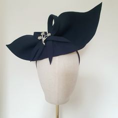 Little Hats for Grand Occasions. Customer information and sizing. Vintage silver style brooch embellished navy blue felt half hat. Unique 1940s 50s inspired navy blue wool felt half hat. Theses are one off hand made pieces. Perfect to complete your vintage outfit. Embellishments, feathers, buttons and pre-loved brooches are lovingly sourced for unique individual pieces. Half hat measures 35cm in lenght and 17cm at it's widest point.2 clips and a black headband are provided for ease of fixing in Mini Hat, Vintage Festival, Hat Wedding, Goodwood Revival, Wedding Fascinators, Vintage Outfit, Black Headband, 50s Vintage, Silver Style