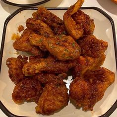 some chicken wings are on a white plate