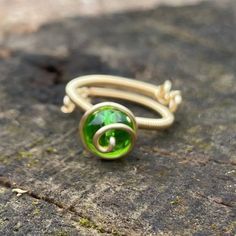 a green ring sitting on top of a rock