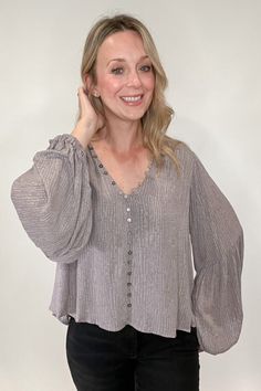 Stunning and sophisticated, you simply cannot go wrong with our Buttons & Billows Blouse. With a lined, v-neck design and lavish gray and lavender undertones and a patterned print, this blouse will have you dressed for your day in no time. Its faux button front ensures a secure, yet comfortable fit with no gapping, while buttons and button hooks run along the neckline for an extra touch of style. A truly luxurious essential that looks and feels perfect. Fit: true to size, Amber is modeling size small. 100% Rayon﻿ Imported. Dripping Springs Texas, Nickel And Suede, Dripping Springs, Effortless Fashion, Velvet Heart, San Antonio Texas, How To Make Handbags, Ethical Fashion, Austin Texas