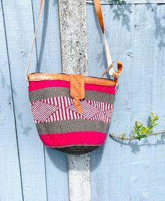 African Kenyan Handmade Traditional sisal tote kiondo handbag. Casual Beach bag Made from sisal Wool and leather handles. The bags are durable And unique. 100% made in Kenya. Measuring about 45  cm wide x 30cm deep. The tote bag is lined inside with black lining. Red Handwoven Pouch Bag, Red Handmade Bucket Bag For Beach, Pink Handwoven Bucket Bag For Travel, Pink Handwoven Travel Bucket Bag, Traditional Straw Bag With Adjustable Strap For Travel, Red Handwoven Crochet Travel Bag, Artisan Beach Bag With Adjustable Strap, Red Handmade Straw Shoulder Bag, Handmade Red Straw Shoulder Bag