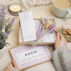 a person is holding some flowers in front of a box that says, rach