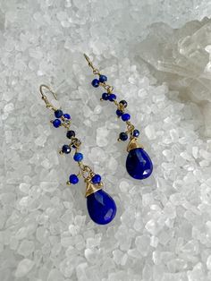 These beautiful dangle earrings consist of 2mm Blue Lapis in a fringe design, and suspended from the bottom are 7X10mm Blue Lapis Lazuli Faceted Briolettes (for some sparkle). All hang from gold-filled ear wires. A very light, sparkly, fun earring. Great for work or that special Holiday event. Length 2" from the top of the ear wire, earring drop is 1 5/8".SEE ALL BLUE LAPIS LAZULI: https://www.etsy.com/shop/ClareSwanDesigns?ref=simple-shop-header-name&listing_id=1204579171&search_query=LAPIS§ Al Blue Drop Earrings With Dangling Beads, Blue Long Drop Teardrop Earrings, Blue Teardrop Dangle Earrings, Blue Long Drop Teardrop Earrings For Pierced Ears, Blue Long Drop Teardrop Earrings With Ear Wire, Blue Wire Wrapped Dangle Earrings, Blue Long Drop Chandelier Earrings, Blue Dangle Jewelry With Dangling Beads, Blue Wire Wrapped Chandelier Earrings