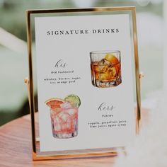 a sign that is on top of a table next to a glass filled with drinks