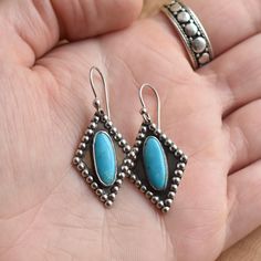 Whether you'll wear these with a little black dress or a dusty pair of cowboy boots, these are going to be your go-to for Turquoise Drop Earrings. Lightweight and bouncy -- Stunning quality AAA Blue Turquoise just pops in this original LBJ Western Design -- with dimension and personality created with the oxidization of the sterling silver beaded wire and shadowbox space. Looks Like Sleeping Beauty Turquoise in color -- similar quality -- uniform, bright blue Turquoise AAA. Have fun wearing these Silver Western Style Earrings, Handmade Southwestern Sterling Silver Earrings, Nickel Free Sterling Silver Western Earrings, Handmade Western Turquoise Earrings, Bohemian Turquoise Earrings Stamped 925, Handmade Western Dangle Earrings, Turquoise Nickel-free Western Earrings, Western Turquoise Nickel-free Earrings, Western Style Turquoise Nickel-free Earrings