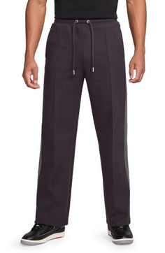 Taping-style side stripes in a softly contrasting hue bring understated branding to these straight-leg pants you'll reach for every weekend. 32 1/2" inseam; 22" leg opening; 12 1/2" front rise; 17 1/2" back rise (size Medium) Elastic/drawstring waist Side-seam pockets; back welt pockets 94% polyester, 6% elastane Machine wash, dry flat Imported Nordstrom x Nike: A curated lifestyle destination where fashion is the ultimate sport Athleisure Straight Leg Bottoms With Side Stripes, Cotton Straight Leg Sweatpants With Side Stripes, Cotton Sweatpants With Side Stripes In Straight Leg, Cotton Sweatpants With Side Stripes, Relaxed Fit Athleisure Bottoms With Contrast Trim, Nike A, Jordan Air, Side Stripe, Drawstring Pants