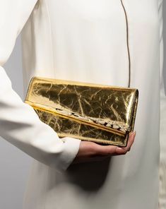 Introducing the latest must-have from Alexis Bittar, the Gold Angular Convertible Crossbody Bag. Crafted with a sliver of molten 14k gold-plated metalwork accentuated with custom-cut Austrian crystals, this bag exudes elegance and sophistication. The sculptural hardware beautifully complements the crinkled Italian leather, finished with a cracked metallic foil. Plus, with its detachable snake chain, this versatile bag can easily be converted from a crossbody to a clutch, making it the perfect ac Crystal Handbag, Evening Jewelry, Convertible Crossbody Bag, Handbag Handles, Ring Sale, Alexis Bittar, Cold Weather Accessories, Metallic Foil, Handbags Online