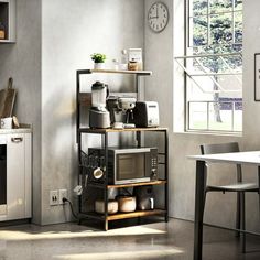 a kitchen area with a microwave, stove and table