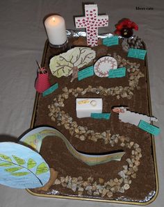 there is a tray that has various items on it and some candles in the background