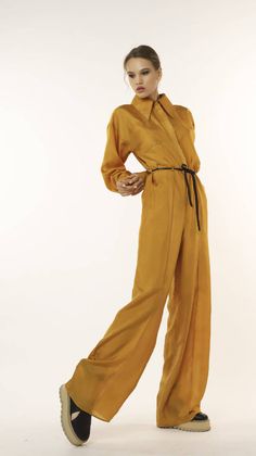 casual-jumpsuit-with-long-sleeves-in-mustard– NOT JUST A LABEL Elegant Yellow Jumpsuits For Workwear, Elegant Yellow Jumpsuits And Rompers For Work, Solid Color Overalls For Fall, Solid Color Overalls Jumpsuit For Fall, Solid Color Fall Overalls, Fall Color Jumpsuits And Rompers In Overall Style, Fall Solid Color Overall Jumpsuits And Rompers, Fall Season Belted Overall Jumpsuits And Rompers, Fitted Yellow Jumpsuits And Rompers For Fall