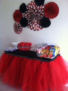 a red tulle skirt with black polka dots on the bottom and candy bar in front