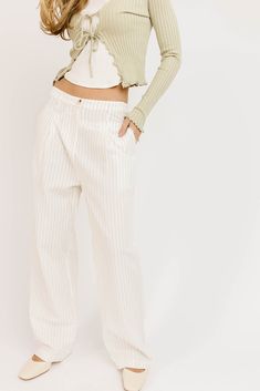 the definition of bomb af bottoms, these slouchy pinstripe linen pants are full of ways to wear. they have that relaxed, cool street style fit, so they’re perfect for beach days, date nights, + weekend hangs. white + black stripes // wide leg, one button zip fly, pockets, belt loops, pleat detailing, exposed hem detailing at waist paired with our july tie top model is 5'8" + wearing a small measurements are approximate + taken while laying flat small : waist 29” inseam 28” length 40” medium : wa Summer High Waist Wide Leg Pants With Vertical Stripes, Summer High Waist Vertical Striped Wide Leg Pants, Casual Wide Leg Pants With Vertical Stripes, Casual High Waist Pinstripe Pants, Spring Wide-leg Pants With Vertical Stripes, Spring Straight Pants With Vertical Stripes, Straight Pants With Contrast Stripes For Spring, Straight Pants With Vertical Stripes For Spring, Chic Striped Wide Leg Cotton Pants