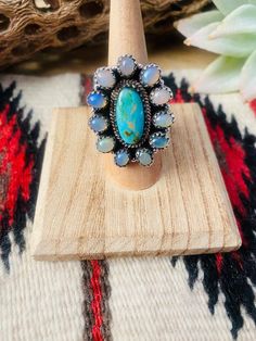 New without tags* JEWELRY TYPE : Ring * METAL : Sterling Silver * MAIN STONE : Opal  This is a beautiful handmade Turquoise, Opal and Sterling Silver Adjustable Cluster Ring. Ring measures 1 3/8 inches long and 1 1/8 inches wide. Stamped Sterling and Nizhoni. So beautiful!   **Non-Native**  Thank you for checking out our store. Please let us know if you have any questions.  2/12/23    Exported By ExportYourStore :) SKU:436783178385_B4E7* Native American Necklace, Bouquet Charms, Turquoise Earrings Dangle, Bridesmaid Gifts Jewelry, Photo Charms, Ring Metal, Body Jewellery, Bridesmaids Gifts, Ring Ring