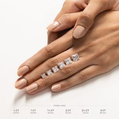 a woman's hand with three diamond rings on it