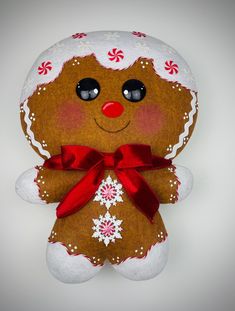 a brown and white teddy bear with red ribbon around it's neck on a white background