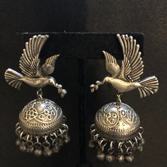 Oxidized Silver bird Jhumka earrings/Silver Jhumka Earrings/Silver Oxidized Earrings/Indian Jhumka Earrings/ Indian Jewelry - Earrings Length: 2.5 Inches - Comes with push back closure - Lightweight Earrings - Silver Oxidized Earrings with simulated stones in silver finish. - Very Elegant and stylish, these Earrings can be paired with any Attire depending upon the occasion and the theme. - The base is pure brass (90%) and pure 92.5 silver (10%) which makes this very sturdy and of good quality. - Silver Earrings With Bells For Festivals, Silver Bell Earrings For Festivals, Traditional Silver Earrings With Bells, Traditional Silver Bell Earrings, Silver Peacock Design Jhumkas For Navratri, Silver Drop Jhumkas For Festivals, Silver Peacock Design Earrings For Diwali, Festive Silver Jhumkas With Peacock Design, Silver Jhumkas Drop Earrings For Festivals