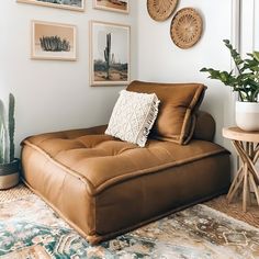 a living room filled with furniture and pictures on the wall