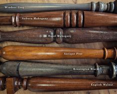 an assortment of old wooden baseball bats on a table with names and numbers in english