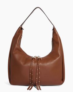 This hobo bag boasts an oversized zipper adorned with studded tassels for a touch of flair. The handle itself is uniquely crafted with intricate stitching details and features a distinctive buckle. Constructed to exude a soft and inviting feel. Gloved Tanned Leather Signature branded hardware Interior zipper pocket and slip pocket Back exterior slip pocket with magnetic snap closure Single strap drop: 11.5" 12.5"W x 17"H x 6.25"D Weight approximately: 1.6 lbs Leather Hobo Bag With Zipper Closure, Leather Hobo Bag With Zipper Closure For Fall, Fall Hobo Bag With Zipper And Double Handle, Fall Double Handle Hobo Bag With Zipper, Brown Satchel Hobo Bag With Palladium Hardware, Fall Shoulder Bag With Metal Hardware And Double Handle, Chic Brown Hobo Bag With Silver-tone Hardware, Brown Hobo Bag With Silver-tone Hardware, Luxury Fall Hobo Bag