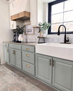 a kitchen with gray cabinets and white counter tops