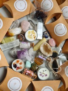 several different types of soaps and candles in brown paper bags on a table top