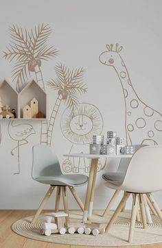 two children's chairs sitting at a table in front of a giraffe wall mural