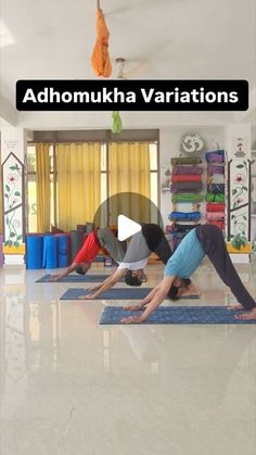 two people are doing yoga in the middle of a room