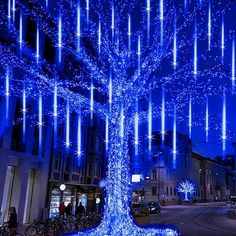 a blue lighted tree in the middle of a street