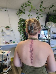 a woman with a tattoo on her back