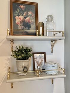 two shelves with flowers and candles on them