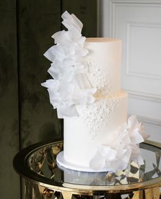 a white wedding cake with flowers on top