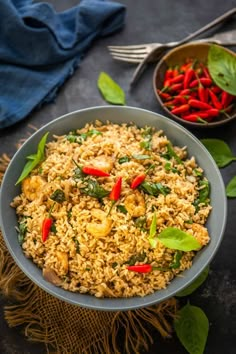 a bowl filled with rice and vegetables on top of a table