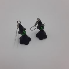 These witch earrings are a must-have accessory for any lover of the dark and magical. Handmade with 4mm black beaded pieces, green bead head, and silver ear-wire, these earrings are a simple yet stylish addition to any Halloween outfit. Whether you're attending a party or just looking to add some spooky flair to your everyday look, these earrings are a perfect choice. Don't miss out on this must-have accessory for the season of the witch! 🪄 Free shipping on all orders $35 or above 🪄 Each piece Black Single Earring For Halloween, Witchy Black Nickel-free Earrings, Black Beaded Dangle Earrings For Halloween, Black Dangle Beaded Earrings For Halloween, Witchy Drop Earrings, Green Halloween Party Earrings, Green Halloween Dangle Earrings, The Season Of The Witch, Earrings Gothic