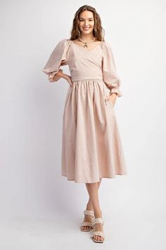 This dress features a sweetheart neckline and bubble sleeves with elasticized cuffs, as well as a smocked waistline and back. The adjustable top allows for multiple looks, and the side pockets add functionality. Its loose and flowy fit offers comfort and style. Length measures at 45.5" with a bust measurement of 14.5". Casual Midi Dress With Gathered Sleeves And Square Neck, Spring Daywear Puff Sleeve Dress With Bishop Sleeves, Spring Puff Sleeve Dress With Bishop Sleeves For Daywear, Modest Midi-length Puff Sleeve Dress With Gathered Sleeves, Puff Sleeve Midi Dress With Smocked Cuffs For Brunch, Summer Long Sleeve Puff Dress With Pleated Sleeves, Chic Dresses With Smocked Back Relaxed Fit, Casual Puff Sleeve Dress With Balloon Sleeves For Daywear, Chic Dresses With Smocked Back And Relaxed Fit