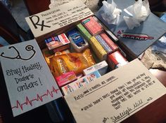 an assortment of medical supplies is displayed in a box on a table with notes attached to it