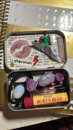 two tins filled with different items sitting on top of a table