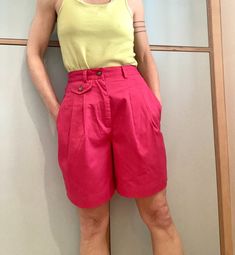 "Love these! Kind of fuchsia/bubblegum pink high waisted shorts. Elastic back for ease of fit! Roomy bilateral pockets, cute mini front button pocket and a back button pocket. Belt loops. Pleated. Very comfortable & flattering! Cute statement shorts! Waist 25\" unstretched  Hip 39\" widest 6.5\" inseam Waist to hem 18.5\"" Summer Pink Bottoms With Pockets, Pink High-waisted Shorts With Pockets, Pink Cotton Bottoms With Short Inseam, Pink High-waisted Bermuda Shorts For Spring, Pink Bermuda Bottoms With Relaxed Fit, Fitted Pink Shorts With Pockets, Pink Shorts With Pockets And Short Inseam, Pink Relaxed Fit Shorts With Pockets, Pink Fitted Cotton Shorts