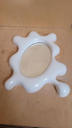 a white object sitting on top of a wooden table