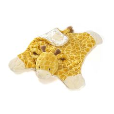 a stuffed giraffe laying on top of a blanket