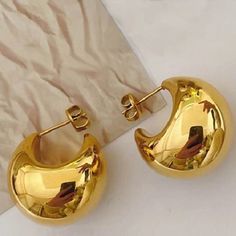 Looking for a striking accessory that will elevate your style? These Polished Gold Plated Metal Hammered Hoop Earrings will do just that! Made with high-quality metal these hoop earrings feature a chic geometric design that's perfect for any occasion - whether it's a party, anniversary, date night, or vacation. And not only are they a great gift for brides, friends, and family, but they also make a stunning addition to any girlfriend's jewelry collection. Don't settle for ordinary earrings - mak Trendy Gold Crescent Earrings, Semi-circle Metal Hoop Earrings, Trendy Crescent Earrings For Pierced Ears, Metal Semi-circle Hoop Earrings For Pierced Ears, Semi-circle Metal Hoop Earrings For Pierced Ears, Metal Semi-circle Hoop Earrings, Blue Floral Print Dress, Girlfriend Jewelry, Wholesale Earrings