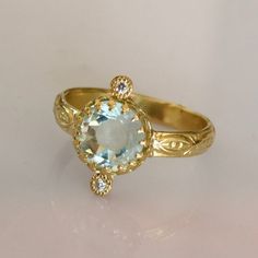 Aquamarine Solitaire Ring. Gemstone of breath, Confidence, clarity and Love. * Pristine Brazilian Rose Cut Aquamarine * 18k Solid Gold * 2 VS SI 0.01ct Natural Brilliant Ethically sourced Diamonds * Sizing included from 4us to 7.5us *Free worldwide Shipping Custom orders Welcomed! For more rings: https://www.etsy.com/shop/templejewelsibiza/items?section_id=21449468 To my shop: https://www.etsy.com/shop/templejewelsibiza Anniversary Fine Jewelry Topaz Ring With Rose Cut Diamonds, Anniversary Topaz Ring With Rose Cut Diamonds, 14k Gold Engraved Ring With Rose Cut Diamonds, Heirloom Rings With Diamond Accents And White Topaz, Heirloom Style Rings With Diamond Accents And White Topaz, Heirloom White Topaz Ring With Diamond Accents, Heirloom Style White Topaz Ring With Diamond Accents, Rings With Rose Cut Diamonds And Blue Topaz, Fine Jewelry Blue Topaz Rings With Rose Cut Diamonds