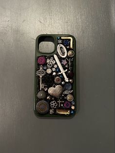 a cell phone case with buttons and keys on the back, sitting on top of a metal surface